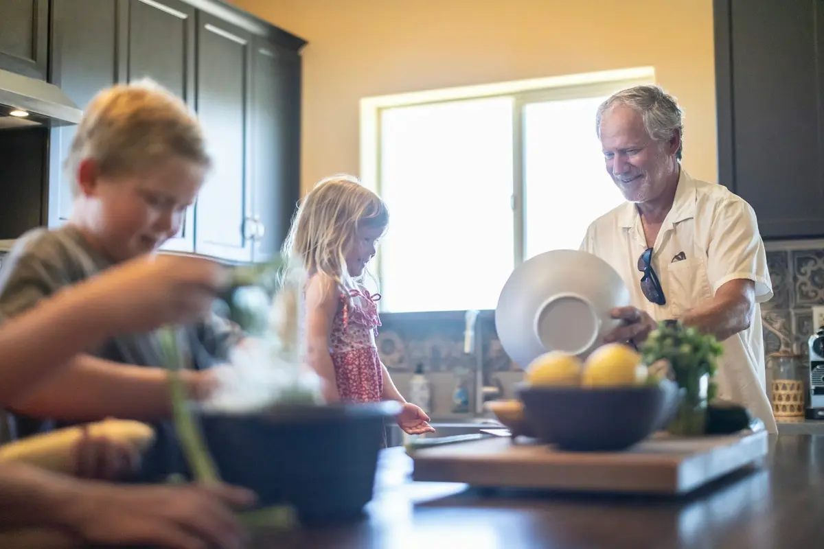 A family preparing food in a sunlit kitchen, clean tap water for Broward County homes