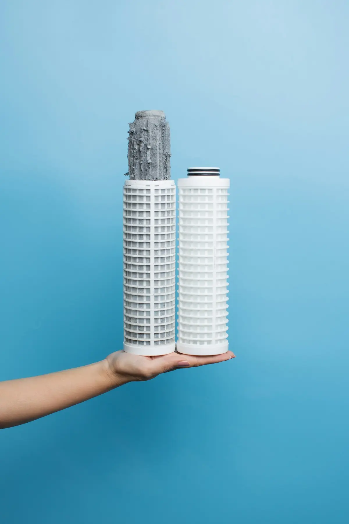A fouled water filter cartridge beside a clean one, whole-house water filtration in Broward County